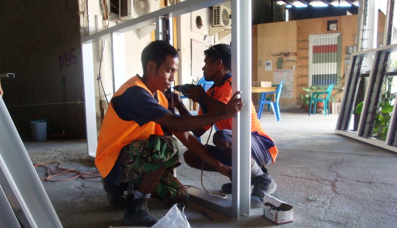 DBS II staff making window frames.