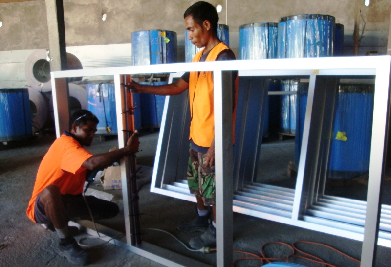 DBS II staff making window frames.